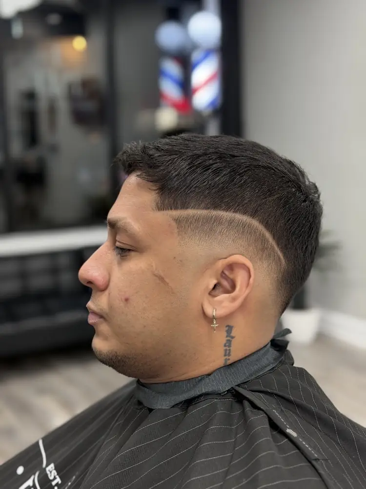 Client with a skin fade and a hard part, fresh out of the chair at JMT