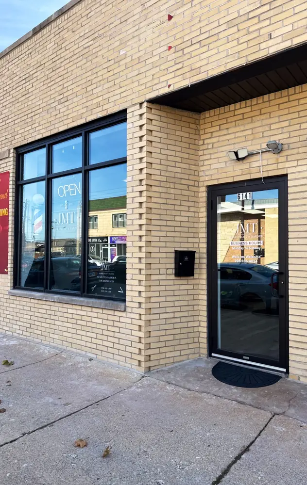 JMT storefront at 6141 W 26th St with the logo on the window and door